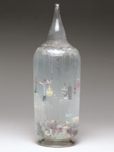 Image: Large glass bottle containing glass amulets, French, c 1870-1920